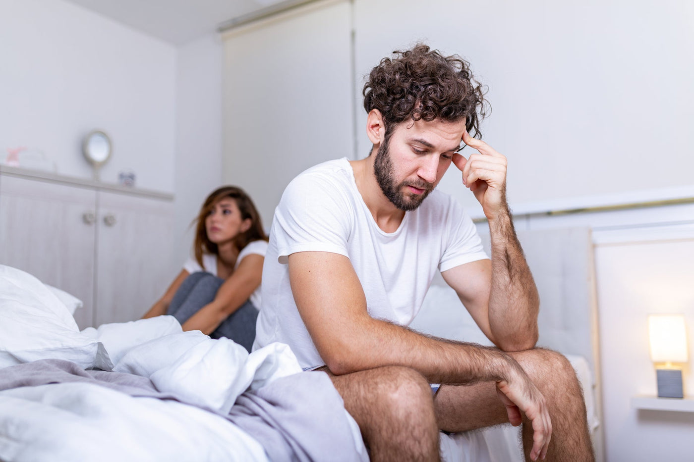 frustrated man sitting in bed