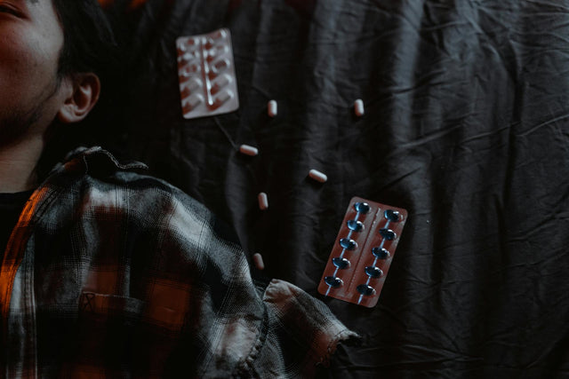 a man is stressed and lying on bed