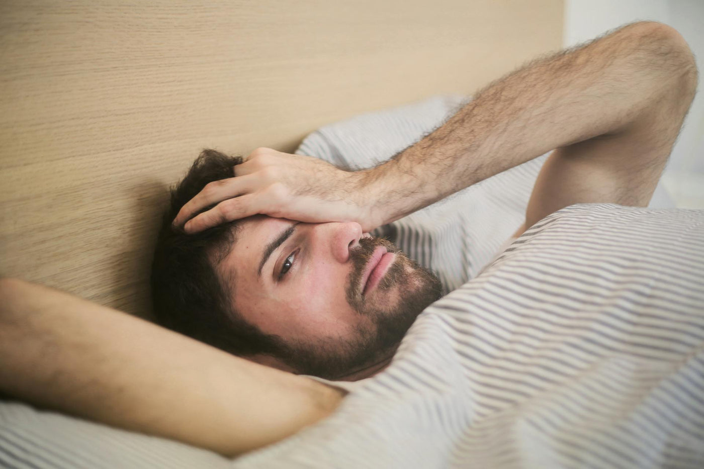Young men stressed on bed 