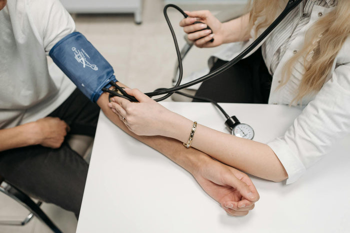 A Healthcare Worker Measuring a Patient's Blood Pressure