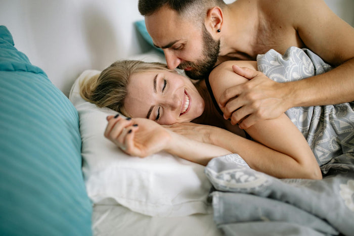 Happy intimate couple on bed